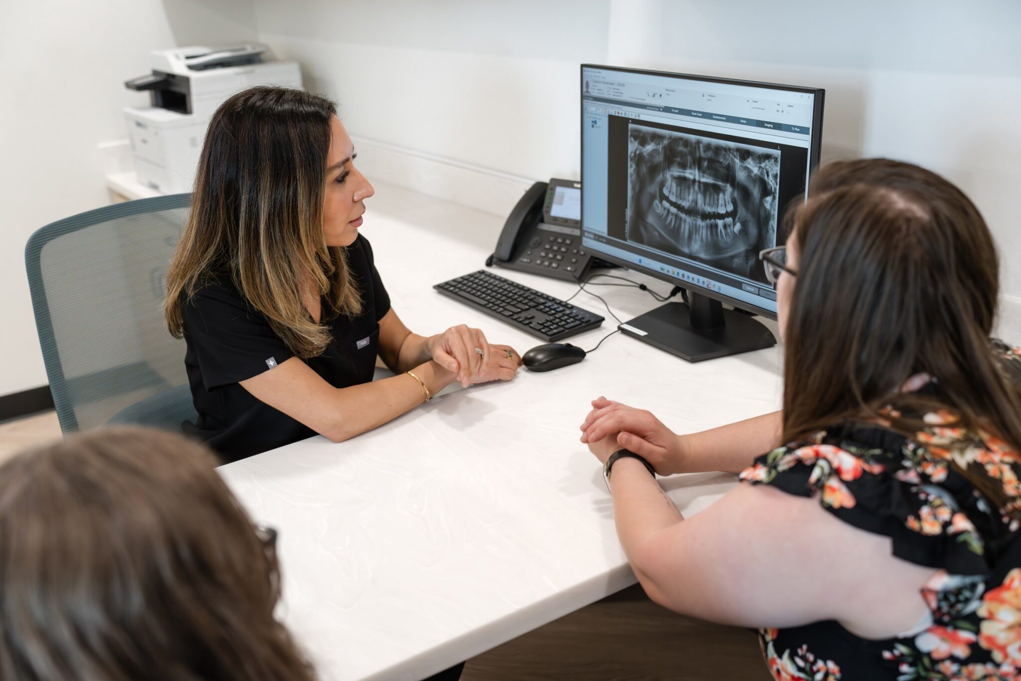 Dr. Mona Rezapour reviewing a patient x-ray at Luv Braces in Austin