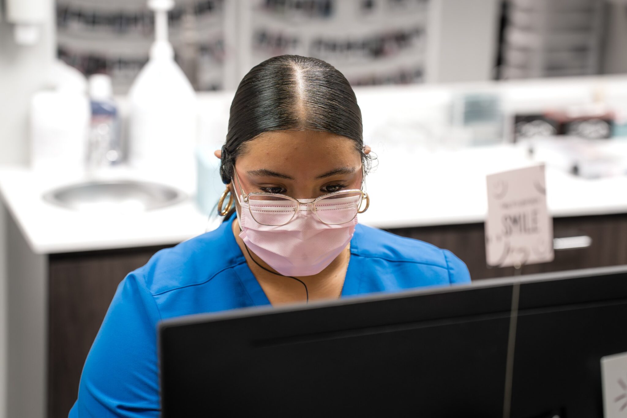 Luv Braces front desk team member working at the office computer