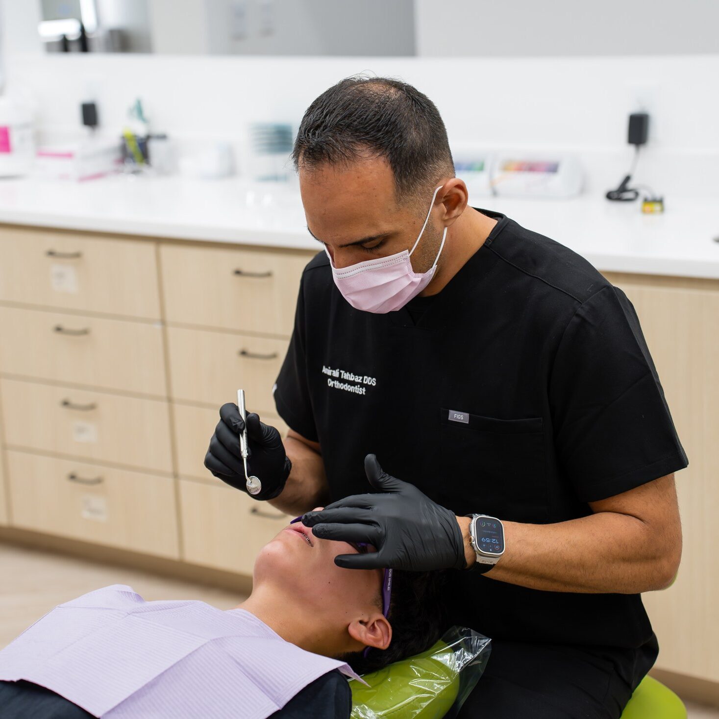 Orthodontist treating a young patient in the chair at Luv Braces
